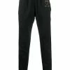 Moschino logo plaque track pants