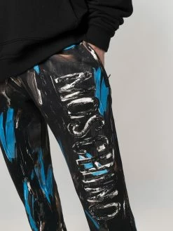 Moschino painted logo trousers
