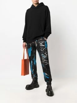 Moschino painted logo trousers