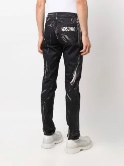 Moschino faded logo-print trousers
