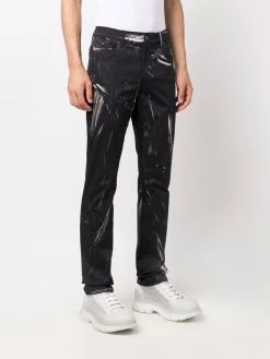 Moschino faded logo-print trousers